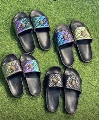 a group of colorful slide sandals on grass