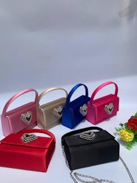 four different colors of satin handbags with hearts on them